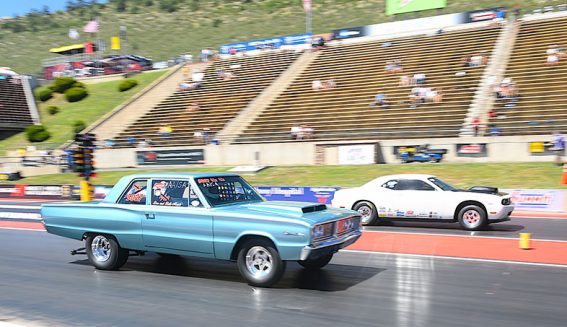 blue vehicle on the starting line of a drag strip