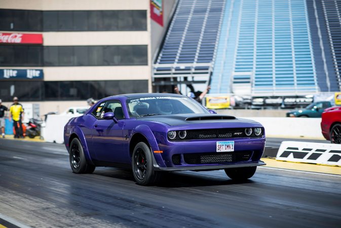 dodge vehicle racing down a drag strip