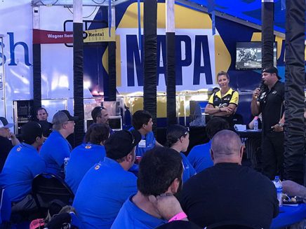 leah pritchett and matt hagan speaking to a tent full of students