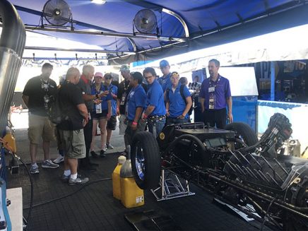 students getting a tour around a vehicle