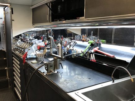 tools and vehicle parts inside matt hagan's trailer