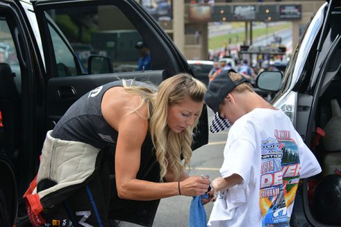 leah pritchett signing an autograph for a young boy