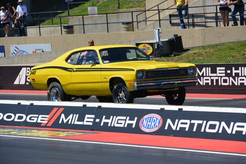 yellow vehicle on the starting line of a drag strip