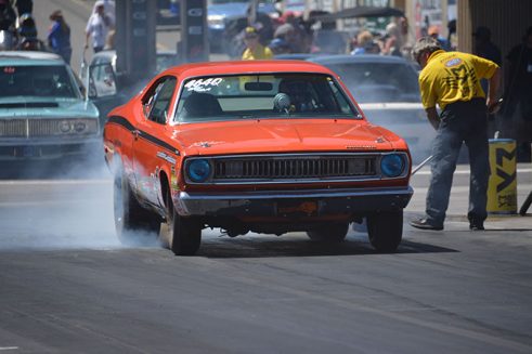 orange vehicle doing a burnout