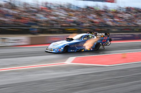 matt hagan's funny car racing down the drag strip