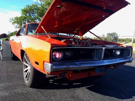 an orange vehicle with the hood open