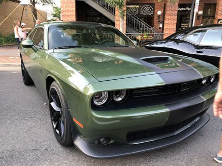 green vehicle with a thick black stripe on the hood