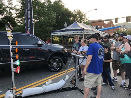 enthusiasts playing a drag strip game