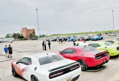 several vehicles parked around the perimeter of a parking lot