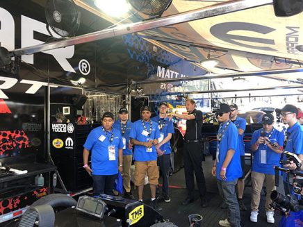 students getting a tour around a vehicle