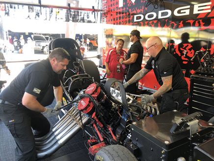 matt hagan with his crew team working on his funny car