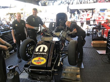 crew team working on matt hagan's funny car