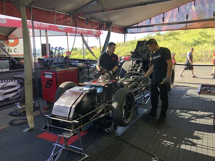 crew members working on cruz pedregon's funny car