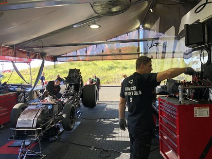 crew members working on cruz pedregon's funny car