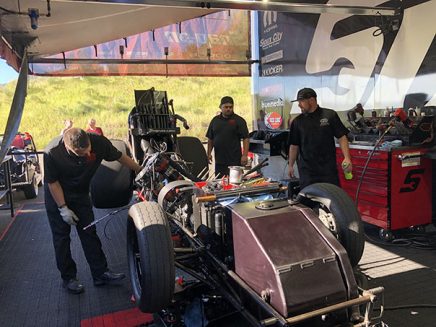 crew members working on cruz pedregon's funny car