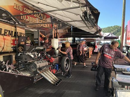 crew working on jim campbell's funny car