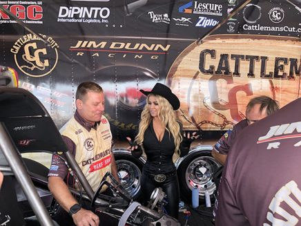 carmen electra being shown jim campbell's funny car