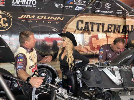 carmen electra being shown jim campbell's funny car