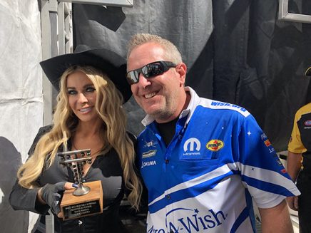 carmen electra holding a trophy with tommy johnson jr