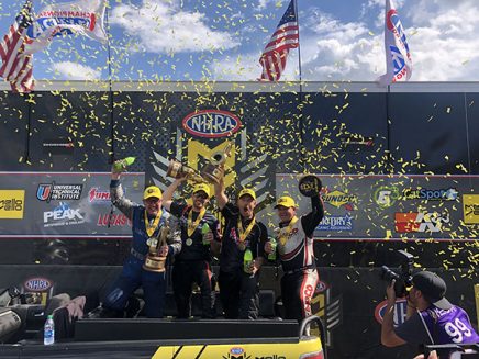 team holding trophies with confetti