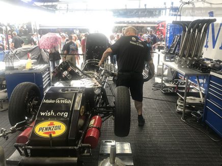 crew working on tommy johnson jr's funny car