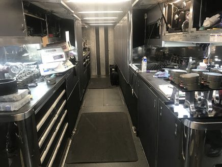 tools and vehicle parts inside jack beckman's trailer