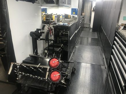 tools and vehicle parts inside jack beckman's trailer