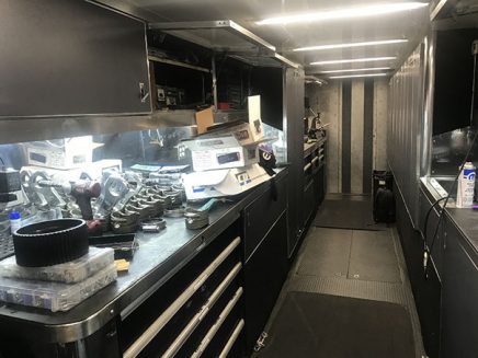 tools and vehicle parts inside jack beckman's trailer