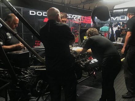 leah pritchett's crew team working on her top fuel dragster