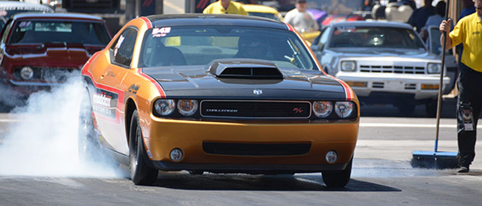 orange vehicle doing a burnout