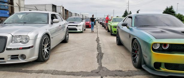 many vehicles parked in two parallel lines