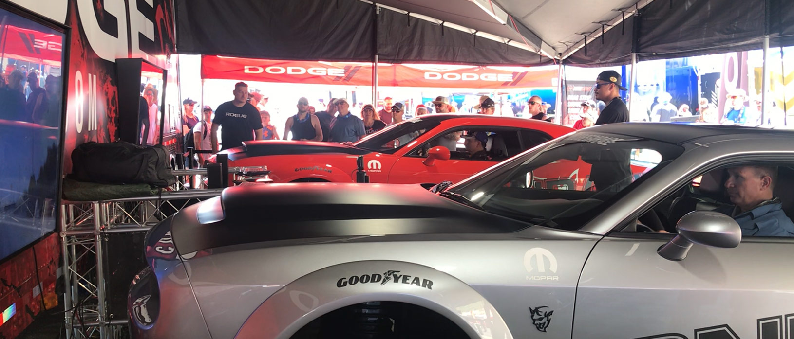 enthusiasts racing in srt demon simulators