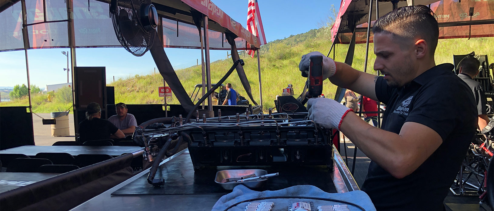 crew member workin in cruz pedregon's pit area