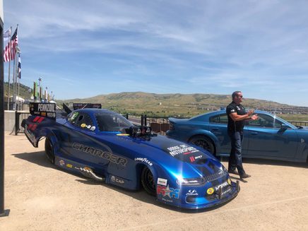 matt hagan standing next to his 2020 dodge charger srt hellcat widebody funny car