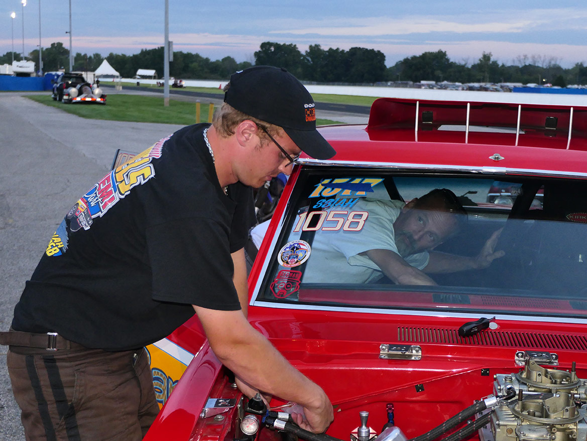 man working under the hood of his dodge vehicle