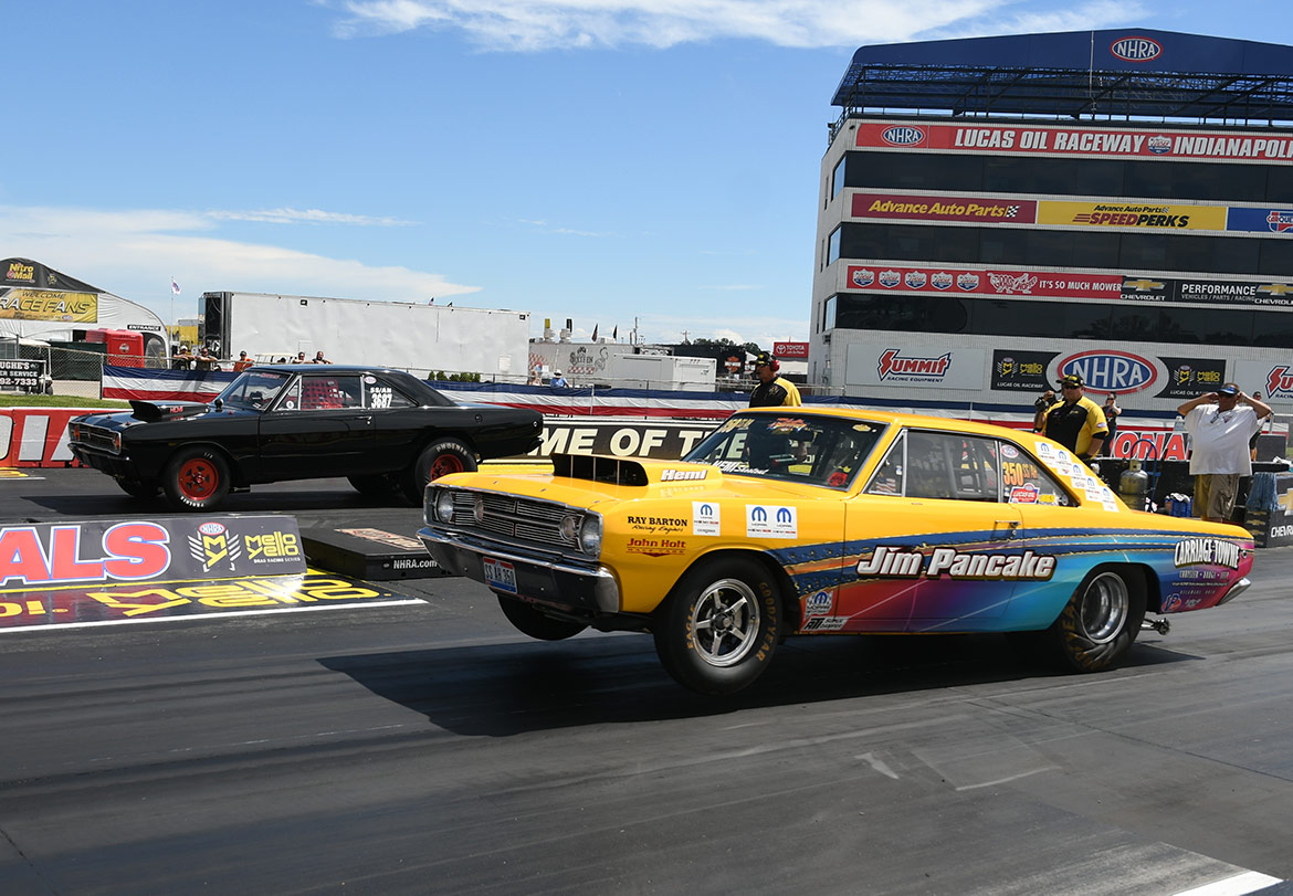 two dodge vehicles at the starting line of a drag strip