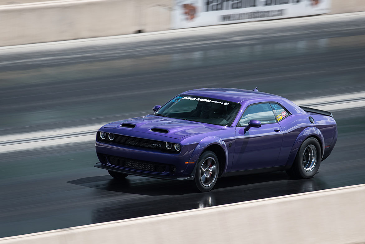 dodge vehicle racing down a drag strip