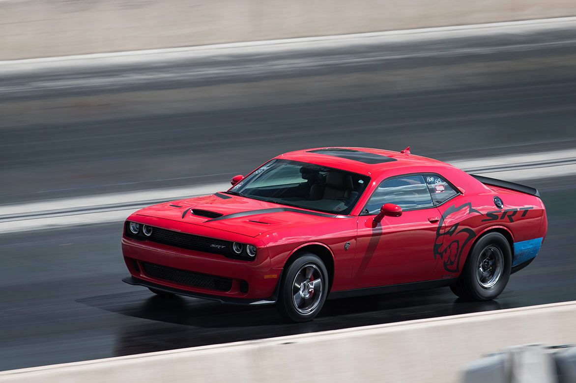 dodge vehicle racing down a drag strip