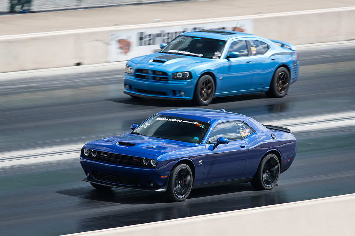 dodge vehicles racing down a drag strip