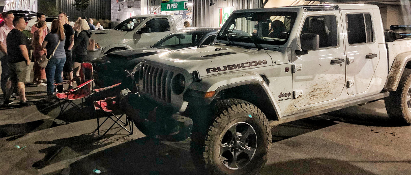 a crowd next to a jeep gladiator