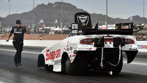 cruz pedregon funny car on the starting line of a drag strip 