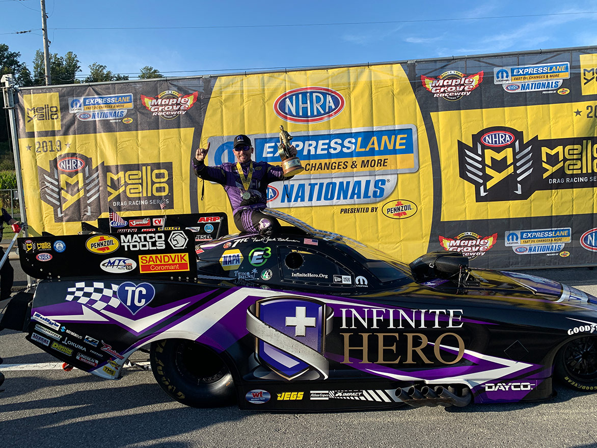 jack beckman with his funny car and trophy