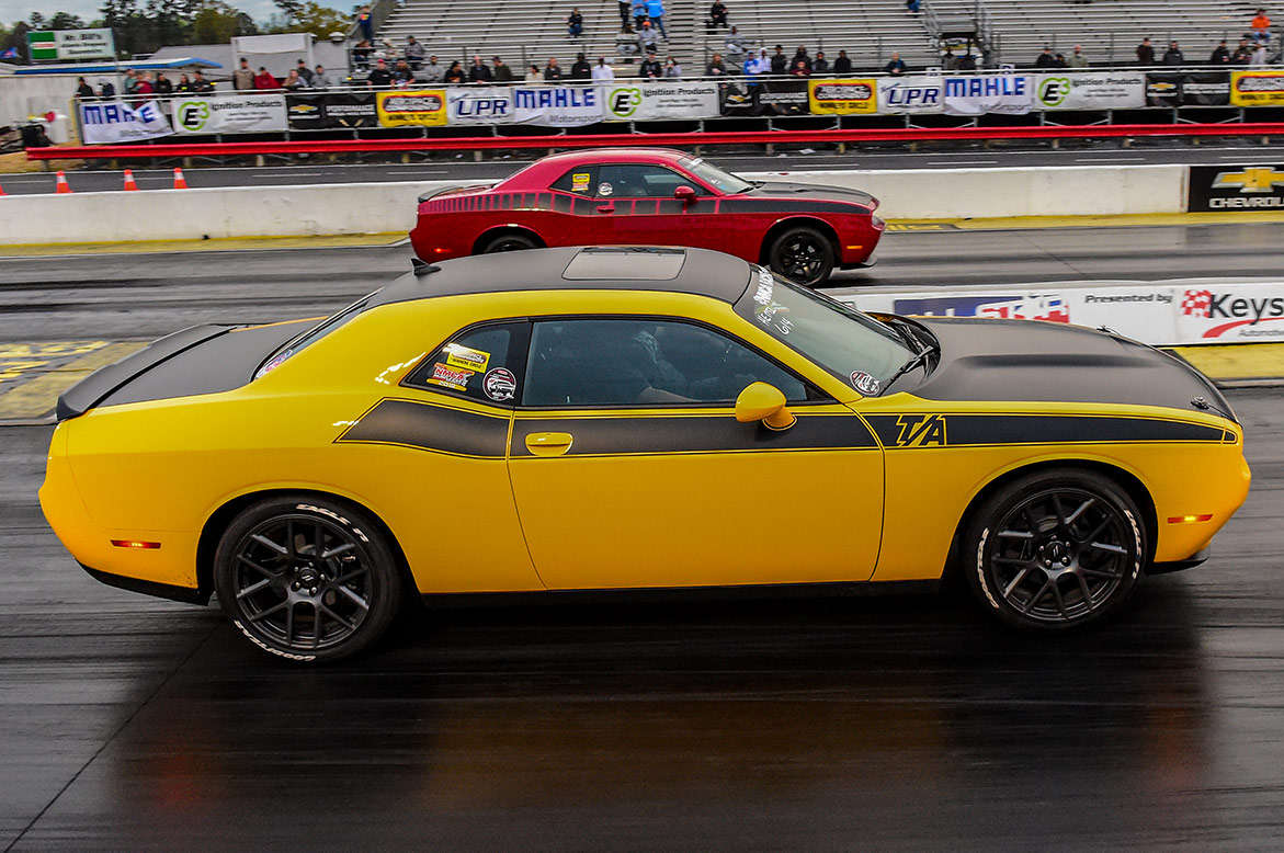 two dodge vehicles at the starting line of a drag strip