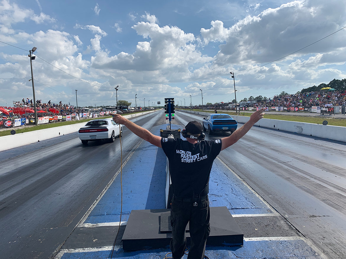 two dodge vehicles drag racing on a drag strip