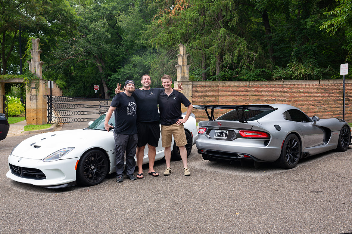 three men standing with two Dodge Viper ACR-e vehicles