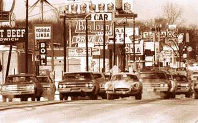 vehicles driving down a city road