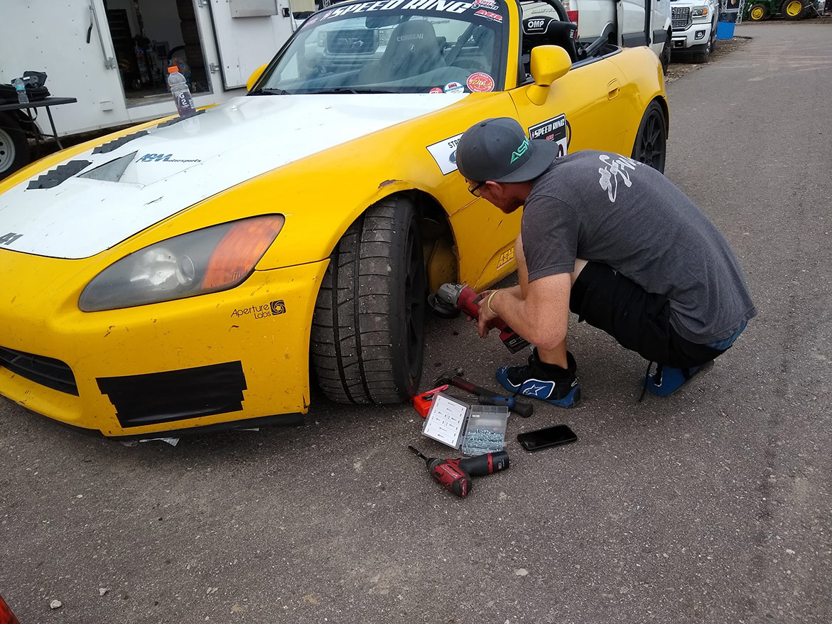 man working on vehicle wheel