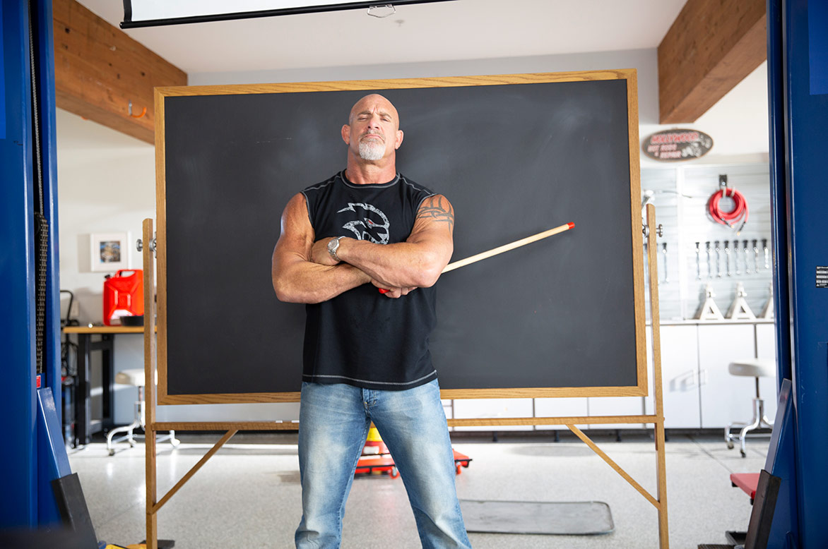 bill goldberg standing in front of a chalkboard