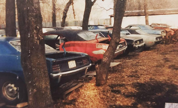 several old vehicles parked outside