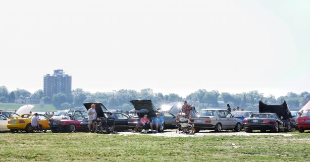 people viewing cars on display